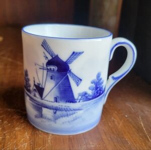 vintage Delft blue and white porcelain mug featuring a hand-painted windmill...
